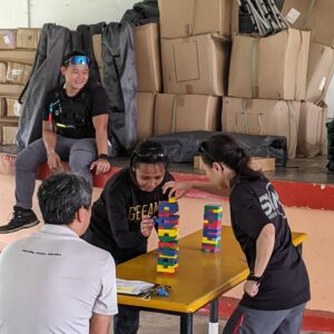 two persons playing jenga